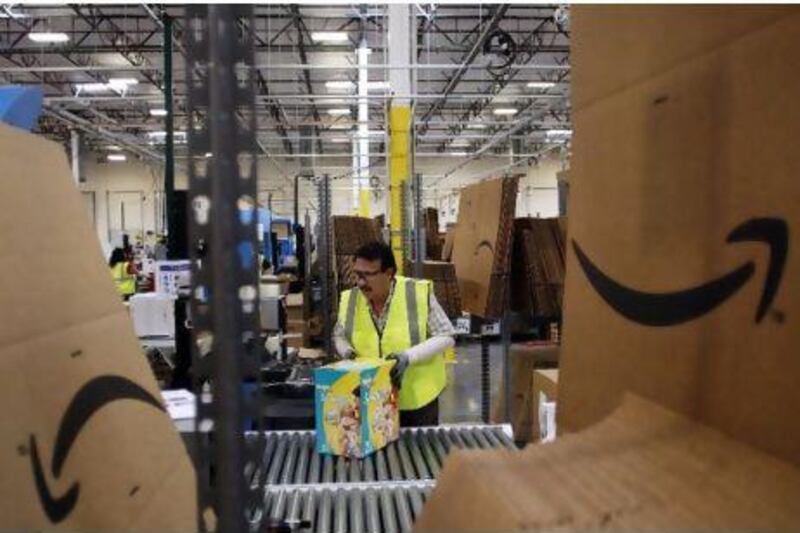 Mario Garica pushes a box of diapers along a conveyor belt at the Amazon.com Phoenix Fulfillment Center in Goodyear, Arizona. Seattle-based Amazon.com, which started as a book seller, has expanded to products such as food and motor parts as it tries to become a general merchandiser. Bloomberg