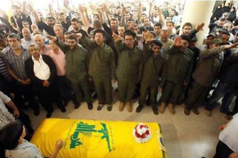 Hizbollah members support relatives of Saleh Ahmed Sabagh during his funeral in the port-city of Sidon, southern Lebanon.