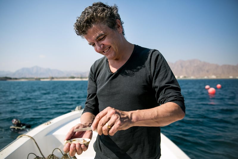 Sean Connolly, chef and owner of a new eponymous restaurant at Dubai Opera, shucks an oyster from Dibba Bay, a new oyster farm in Fujairah.