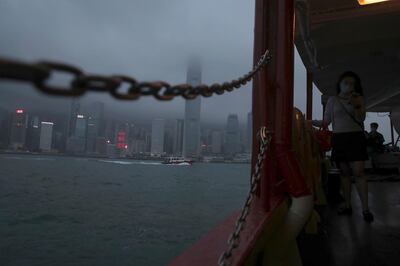 A woman looks at her mobile phone while traveling on ferry in Hong Kong Thursday, May 28, 2020. Chinaâ€™s legislature endorsed a national security law for Hong Kong on Thursday that has strained relations with the United States and Britain and prompted new protests in the territory. (AP Photo/Kin Cheung)