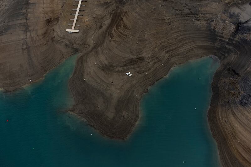 A boat lies stranded above the waterline at Serre-Poncon lake in southern France, after a prolonged winter drought. AP