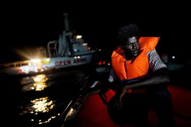 A migrant sits on board a rescue boat in the central Mediterranean Sea. Reuters