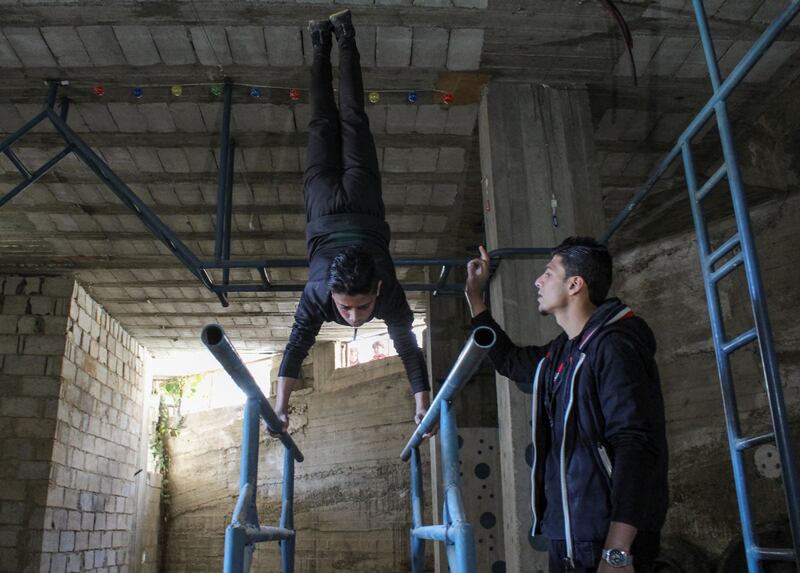 Coach Hassan Mansour trains a young martial artist in Syria.