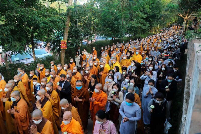 Monks and followers trail behind the coffin. AP Photo