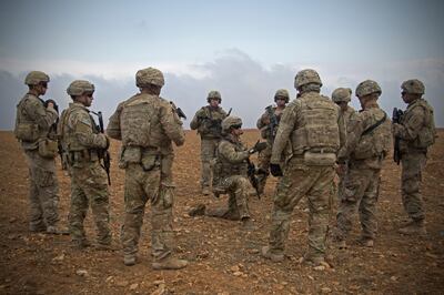 In this Nov. 7, 2018, photo released by the U.S. Army, U.S. soldiers gather for a brief during a combined joint patrol rehearsal in Manbij, Syria. The United Statesâ€™ main ally in Syria on Thursday, Dec. 20, 2018, rejected President Donald Trumpâ€™s claim that Islamic State militants have been defeated and warned that the withdrawal of American troops would lead to a resurgence of the extremist group. (U.S. Army photo by Spc. Zoe Garbarino via AP)