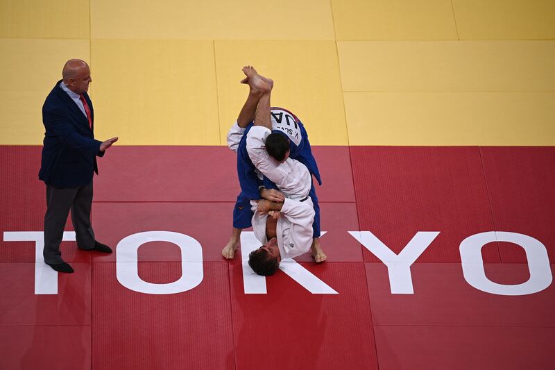Sweden's Tommy Macias, white, defeated UAE's Victor Scvortov in the judo men's -73kg elimination round bout. AFP