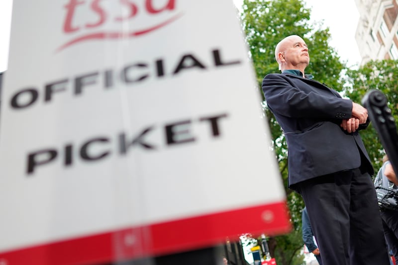 Mick Lynch, general secretary of the RMT union stands on the picket line outside in Euston, London. AP