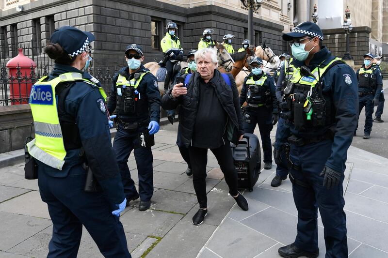 A man leaves after being questioned by police during an anti-lockdown protest in Melbourne, Australia.  EPA