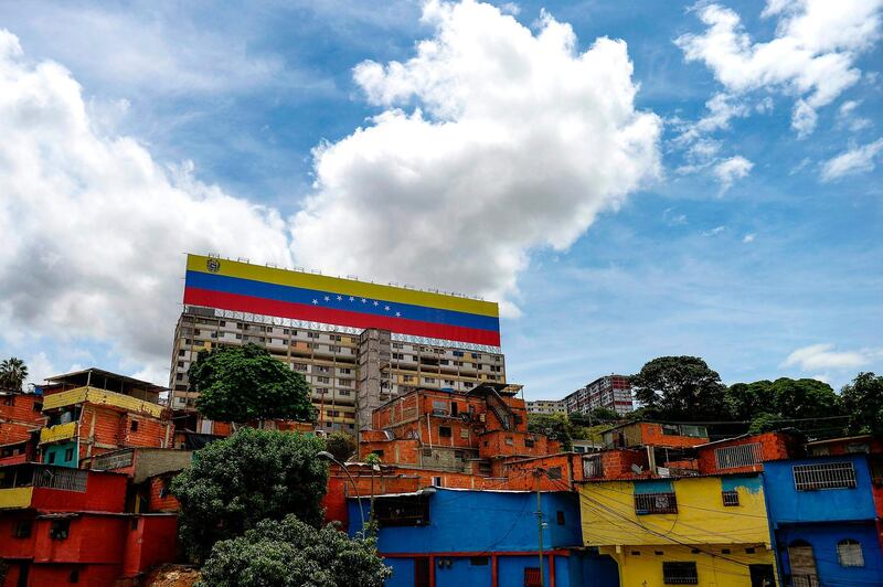 View of a giant Venezuelan national flag sign on top of a building in Caracas, Venezuela.  AFP