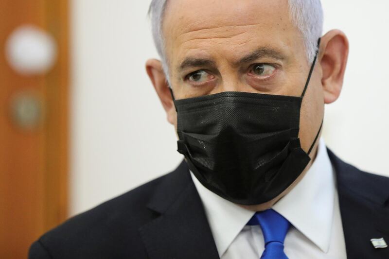 Israeli Prime Minister Benjamin Netanyahu, wearing a face mask, looks as his corruption trial resumes, at Jerusalem's District Court April 5, 2021. Abir Sultan/Pool via REUTERS