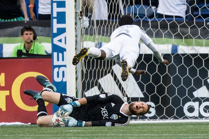 Minnesota United forward Abu Danladi fouls Seattle Sounders goalkeeper Stefan Frei and gets a yellow card during the first half of an MLS football match in Seattle. Bettina Hansen / The Seattle Times via AP