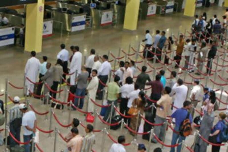 DUBAI, UNITED ARAB EMIRATES - May 8:  People line up for passport control in arrivals at the Dubai International Airport on May 8, 2008.  (Randi Sokoloff / The National)