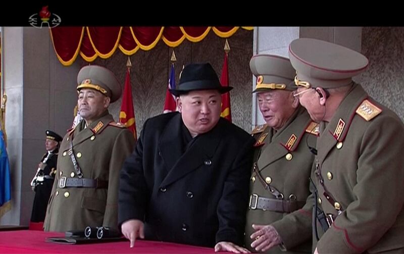 In this image made from video by North Korea's KRT, North Korean leader Kim Jong Un, center, speaks with military officials during a military parade in Pyongyang, North Korea Thursday, Feb. 8, 2018. North Korea held the military parade and rally on Kim Il Sung Square on Thursday, just one day before South Korea hosts the opening ceremony of the Pyeongchang Winter Olympics. (KRT via AP Video)