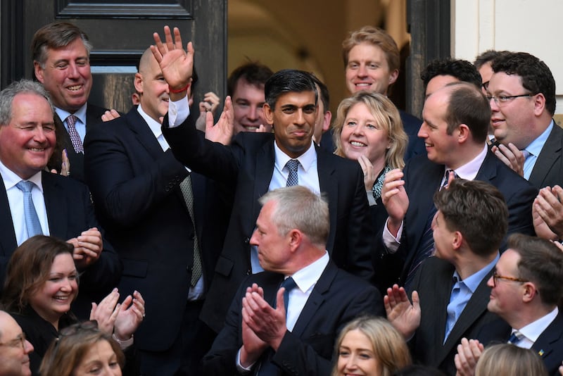 Incoming prime minister Rishi Sunak arrives at the Conservative Party's headquarters with a wave. AFP