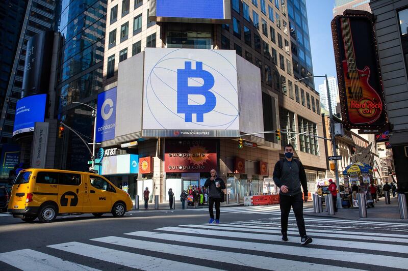 Monitors display Coinbase and Bitcoin signage during the company's initial public offering (IPO) at the Nasdaq MarketSite in New York, U.S., on Wednesday, April 14, 2021. Coinbase Global Inc., the largest U.S. cryptocurrency exchange, is set to debut on Wednesday through a direct listing, an alternative to a traditional initial public offering that has only been deployed a handful of times. Photographer: Michael Nagle/Bloomberg