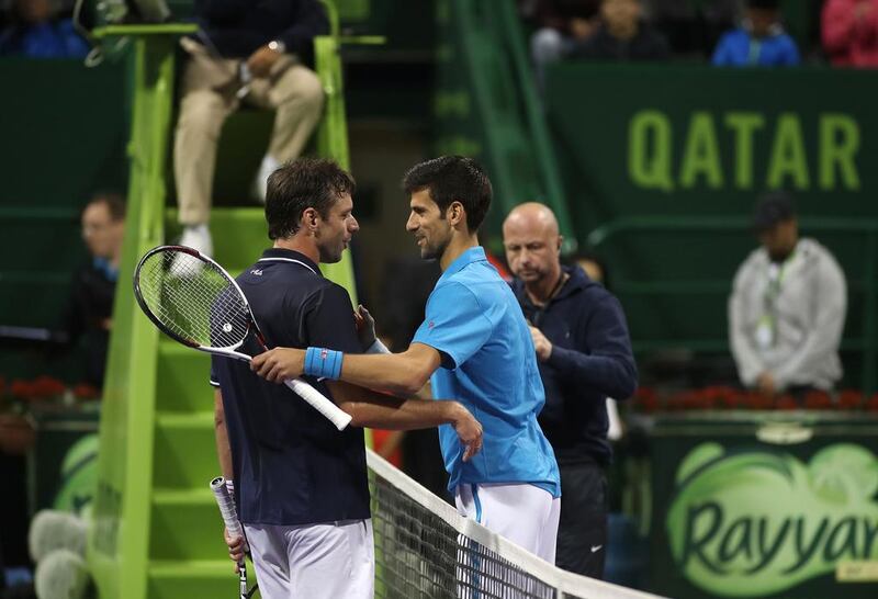 Novak Djokovic, right, shakes hands with Horacio Zeballos after winning their Qatar Open match on Wednesday. Karim Jaafar / AFP

