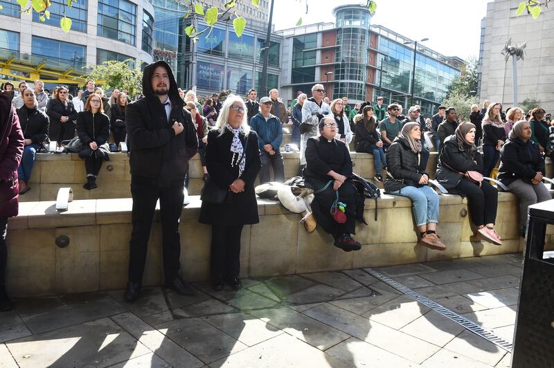 People stand as 'God Save the King' plays during the funeral of Queen Elizabeth II in Manchester. EPA