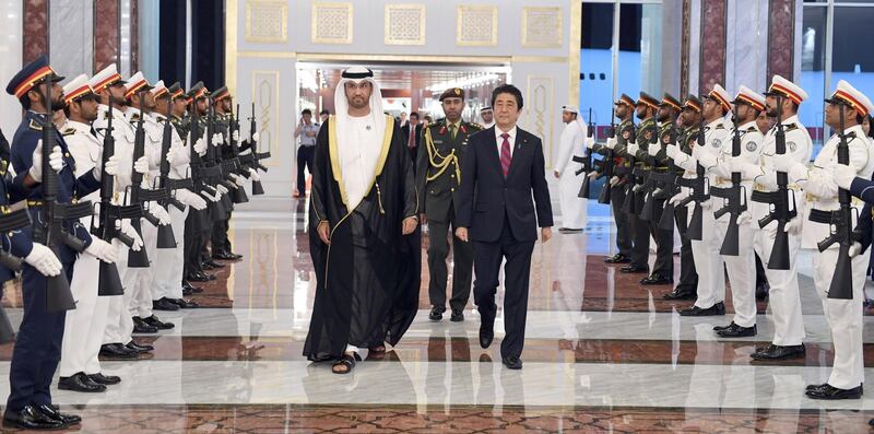 Japanese PM Shinzo Abe (centre right) walks with Dr Sultan Al Jaber, Minister of State, Director-General and CEO of ADNOC Group, the Chairman of Masdar, Chairman of the UAE National Media Council and the Chairman of Abu Dhabi Ports (centre left), upon his arrival to visit Abu Dhabi on the first leg of his Middle East tour. EPA