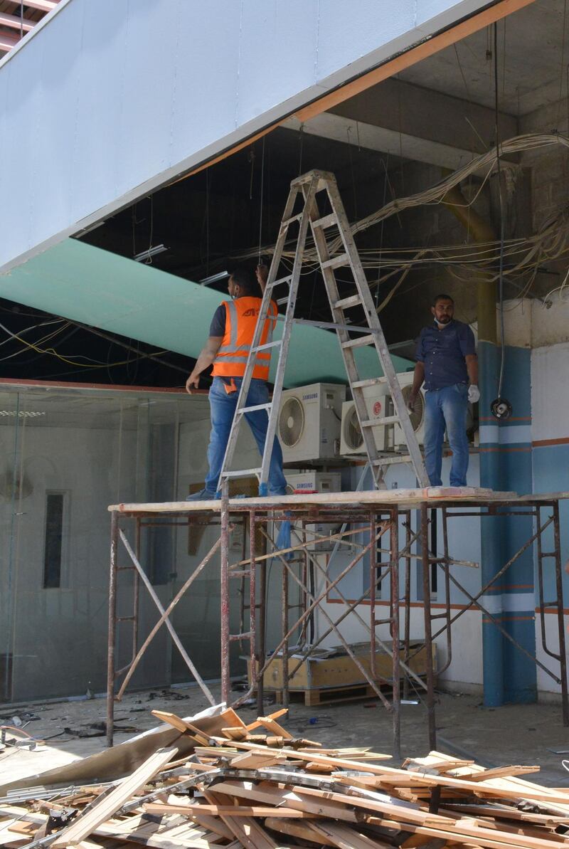 Workers fixing the damage at Abha airport. AFP