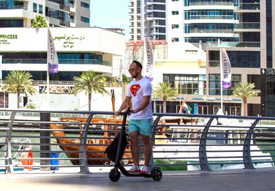 Dubai, United Arab Emirates, May 12, 2020.   Dubai Marina residents on a sunny morning.  An e-scooter rider without a face mask during the coronavirus pandemic.
Victor Besa / The National
Section:  NA
Reporter: