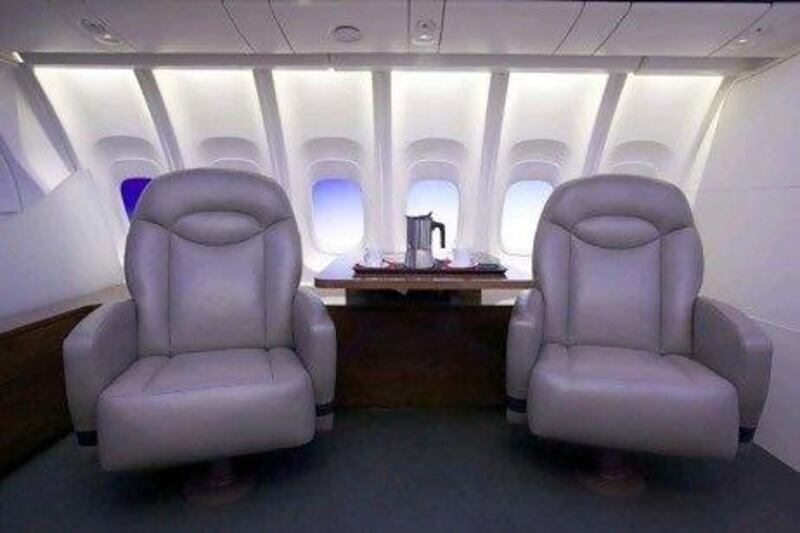 The 747-8 Intercontinental's cabin, featuring larger windows and new lighting, is displayed in a mock up of seats and a table February 12, 2011 at the Boeing Customer Experience Center in Renton, Washington. The new plane, which will be unveiled February 13, 2011, features quieter more fuel efficient engines, more passenger seating and redesigned interiors. Stephen Brashear/Getty Images/AFP