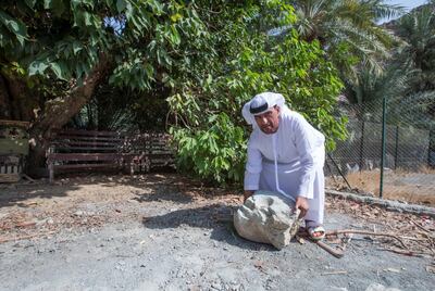 Sharjah, United Arab Emirates-  Abdullah Khilfan Al Naqbi with the marriage rock.  It was believed before that if a man wants to marry the woman, he has to lift this rock at Al Nahwa Village in Sharjah.  Leslie Pableo for The National for Ruba Haza