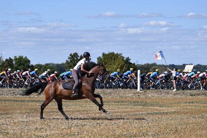 A woman on horseback keeps up with the action on Stage 11. AFP