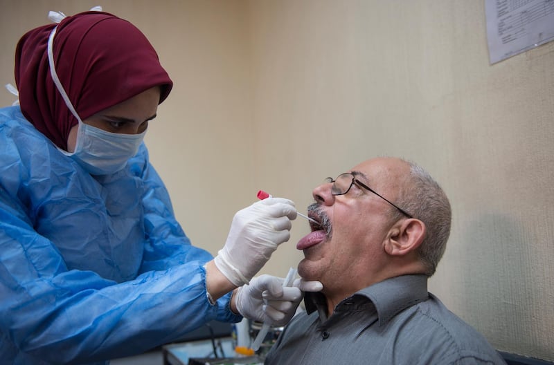 A doctor takes a sample for a Covid-19 test at the Central Public Health Laboratories in Cairo, Egypt.  EPA