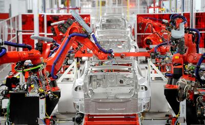 FILE PHOTO: Robotic arms assemble Tesla's Model S sedans at the company's factory in Fremont, California, June 22, 2012.  REUTERS/Noah Berger/File Photo