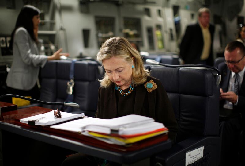 U.S. Secretary of State Hillary Clinton works at a desk inside a C-17 military plane upon her departure from Malta bound for Tripoli, Libya, October 18, 2011. 
REUTERS/Kevin Lamarque  (LIBYA - Tags: POLITICS) *** Local Caption ***  SST109_LIBYA-CLINTO_1018_11.JPG