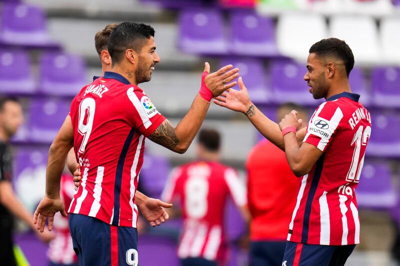 Atletico Madrid's Luis Suarez, left, celebrates with teammate Renan Lodi after scoring his side's second goal against Valladolid on Saturday. AP