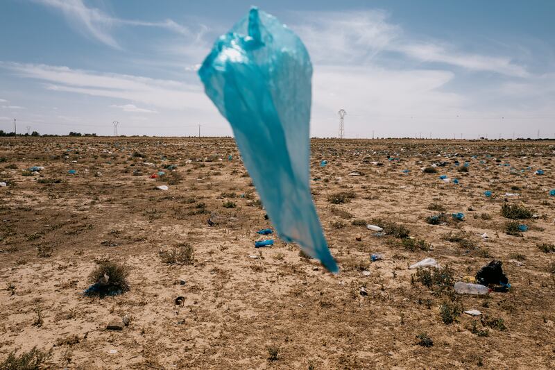 Single-use plastic bags blow across an empty lot on the outskirts of Gabbes, in southern Tunisia. Tunisia has a robust plastics lobby that has kept the country from banning single-use items.