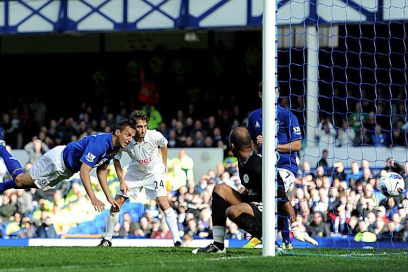 Phil Jagielka equalises for Everton with a diving header during their 3-1 win against Wigan at Goodison Park.