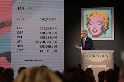 A Christie's auctioneer scans the room for new bids on 'Shot Sage Blue Marilyn' by Andy Warhol. EPA