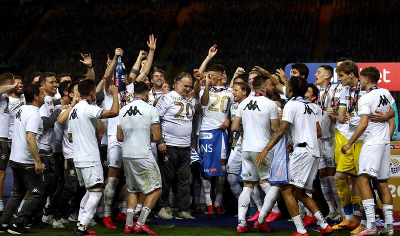 Leeds United manager Marcelo Bielsa, centre, with his players as they lift the Championship trophy after their match at Elland Road. AP