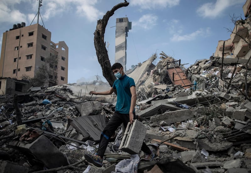 A Palestinian man inspects the damage of a six-storey building destroyed by an early morning Israeli air strike in Gaza city. AP Photo