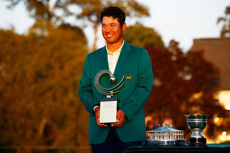 Hideki Matsuyama of Japan poses with the Asia Pacific Amateur Championship trophy during the Green Jacket Ceremony after winning the Masters at Augusta National Golf Club. AFP