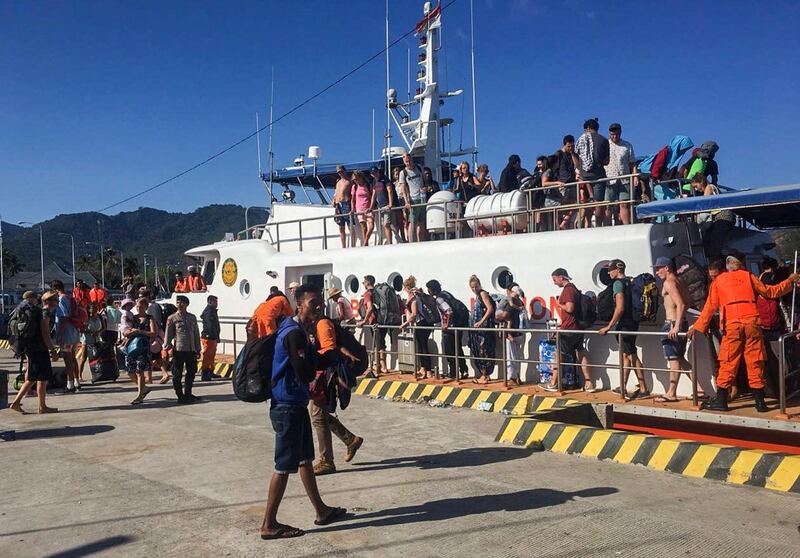 Locals and foreign tourists who were evacuated from Gili islands disembark a rescue ship at Bangsal port, Lombok, West Nusa Tenggara, Indonesia.  EPA