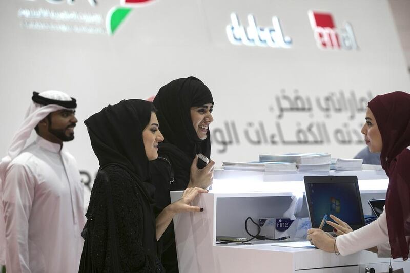 Emiratis speak to recruiters at the Tawdheef jobs fair. Silvia Razgova / The National