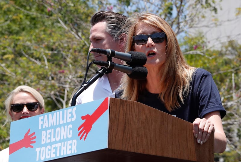American actress Laura Dern, right, addresses protesters as she introduces California Lieutenant Governor Gavin Newson, centre, at a demonstration against the immigration policies of US president Donald Trump in Los Angeles, California. EPA