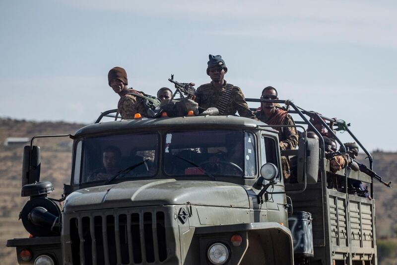 Ethiopian government soldiers ride in the back of a truck on a road near Agula, in the Tigray region of northern Ethiopia, on Saturday, May 8, 2021. As the Tigray Peopleâ€™s Liberation Front and the government forces fight, civilians, and especially children, are suffering heavily. (AP Photo/Ben Curtis)