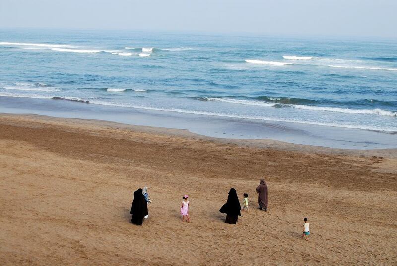 In this photo taken on August 12, 2016, Moroccan women wearing the niqab walk along the beach in Casablanca with their children. Emily Irving-Swift/AFP

