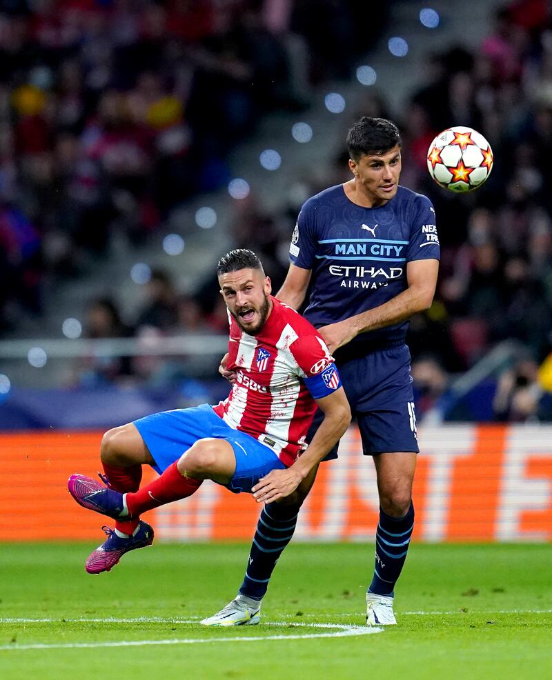 Atletico Madrid's Jorge Koke  and Manchester City's Rodri battle for the ball. PA