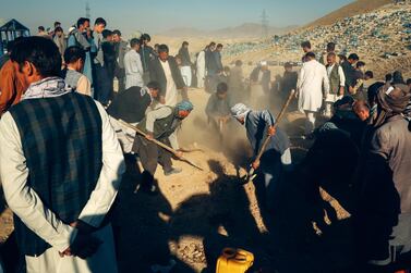 People attend at the burial of victims after a landmine targeted a mini-bus full of passengers in a Taliban controlled area in Afghanistan. EPA/HEDAYATULLAH AMID