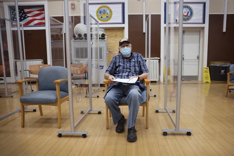 Army veteran William Craig waits to see if he has a reaction after receiving a Covid-19 booster vaccine and an influenza vaccine at the Edward Hines Jr VA Hospital in Hines, Illinois. AFP