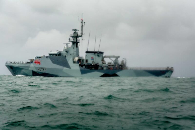 HMS Tamar is deployed as French fishing boats sail into harbour in St Helier. Getty Images