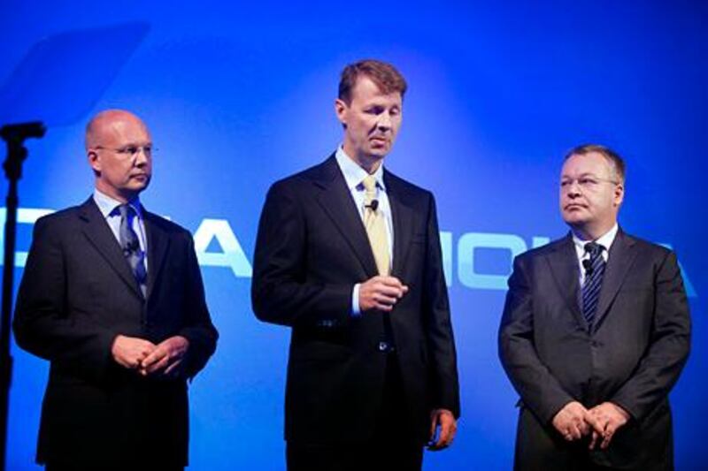 Risto Siilasmaa, interim chief executive officer of Nokia Oyj, center, speaks while Stephen Elop, outgoing chief executive officer of Nokia Oyj, right, and  Timo Ihamuotila, chief financial officer of Nokia Oyj, listen during a news conference at the Dipoli conference center in Espoo, Finland, on Tuesday, Sept. 3, 2013. Microsoft Corp. agreed to buy Nokia Oyj's handset business and license its patents for 5.44 billion euros ($7.2 billion), casting together the lot of two companies trying to stay relevant against fleet-footed technology rivals. Photographer: Ville Mannikko/Bloomberg *** Local Caption *** Risto Siilasmaa; Stephen Elop; Timo Ihamuotila 113531884.jpg