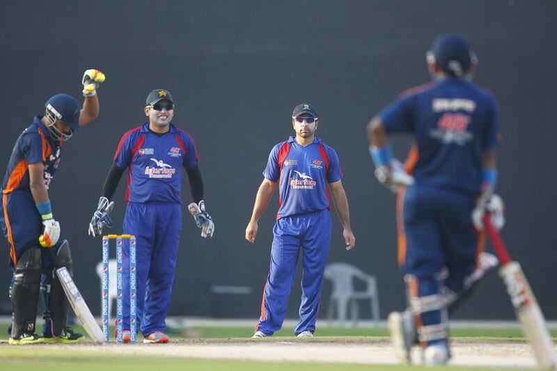 Pakistan's Kamran Akmal playing wicketkeeper for Grand Midwest, with teammate Taufeeq Umar during the Bukhatir Cricket League semi-finals on Thursday in Sharjah.  Jeffrey E Biteng / The National / June 26, 2014