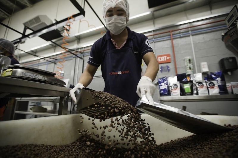 Dubai, United Arab Emirates, Nov 04, 2013 - Workers packing roasted coffee at Coffee Planet roastery warehouse in Jebel Ali. (Jaime Puebla / The National Newspaper) Triska Hamid - Business