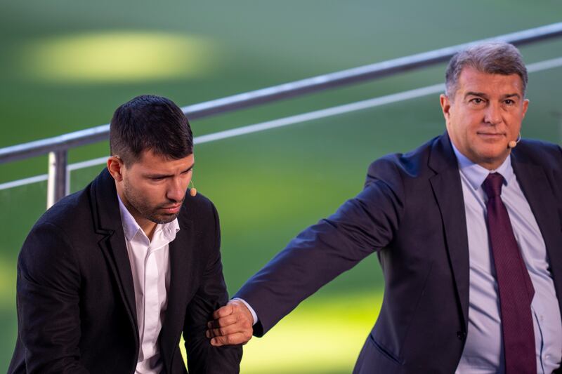 Sergio Aguero is comforted by Barcelona president Joan Laporta. AP